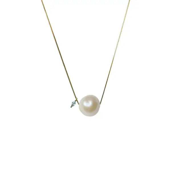 A delicate 18k gold-filled necklace featuring a baroque freshwater pearl and a sparkling moissanite gemstone.